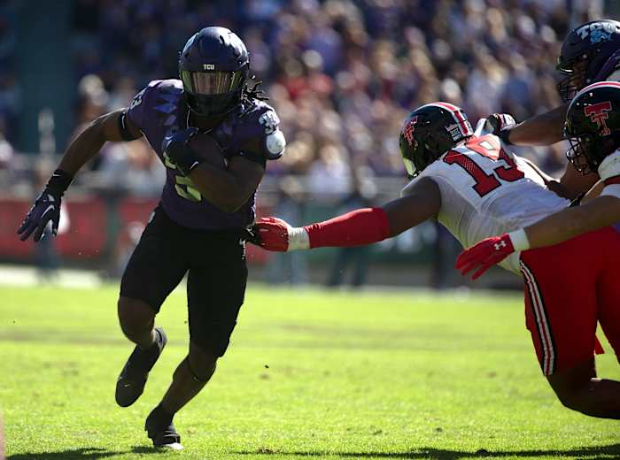 Kendre Miller (33) runs the ball against Texas Tech